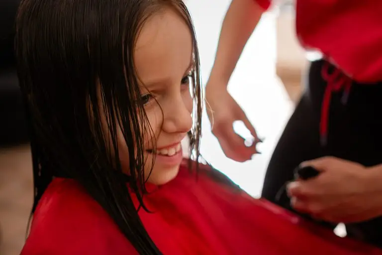 girl smiling during haircut